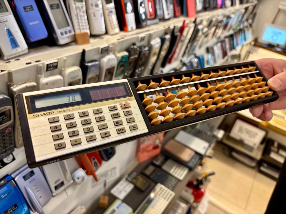 Sharp Elsi Mate EL-429, a calculator with an attached abacus.