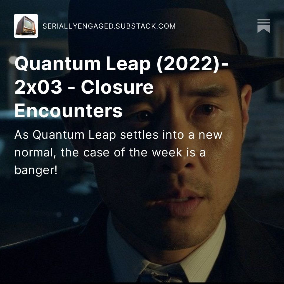 A closeup on the face of a Korean man in a 1950s style hat/suit as he looks surprised.