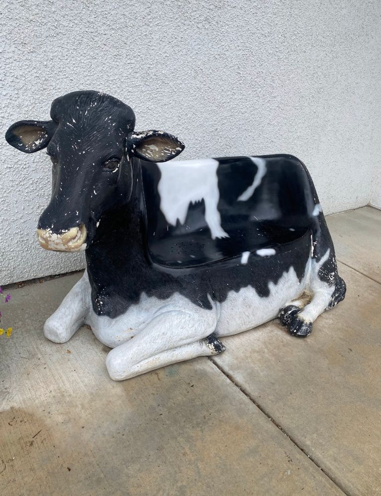 Photo of a Couch, shaped like a cow, hence cow-ch.