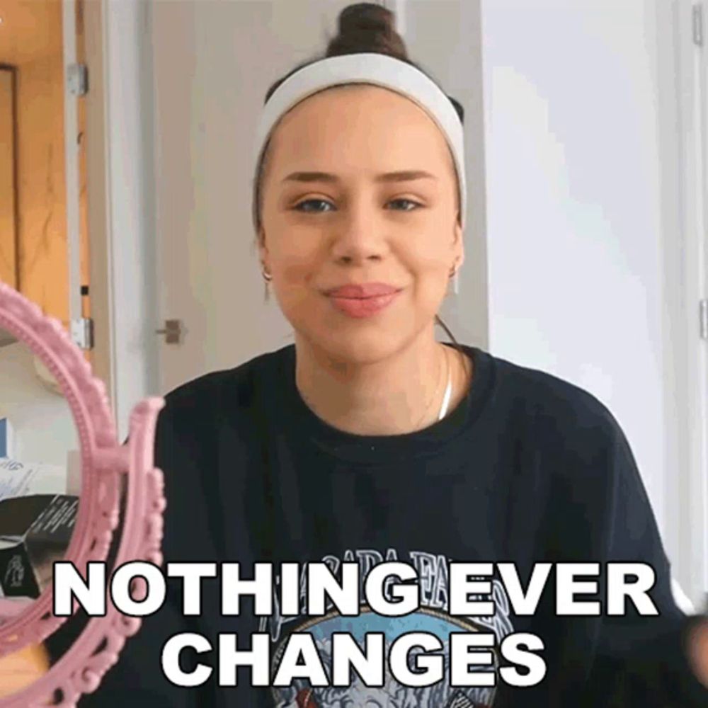 a woman is looking at herself in a mirror with the words " nothing ever changes " above her