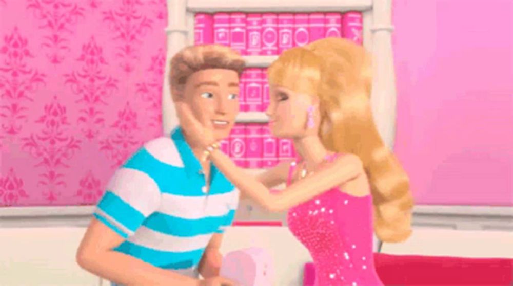 a man and a woman are standing next to each other in front of a bookshelf filled with barbie books .