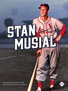 The cover of SABR's book on Stan Musial shows him in uniform, leaning on a bat and staring away from the camera.