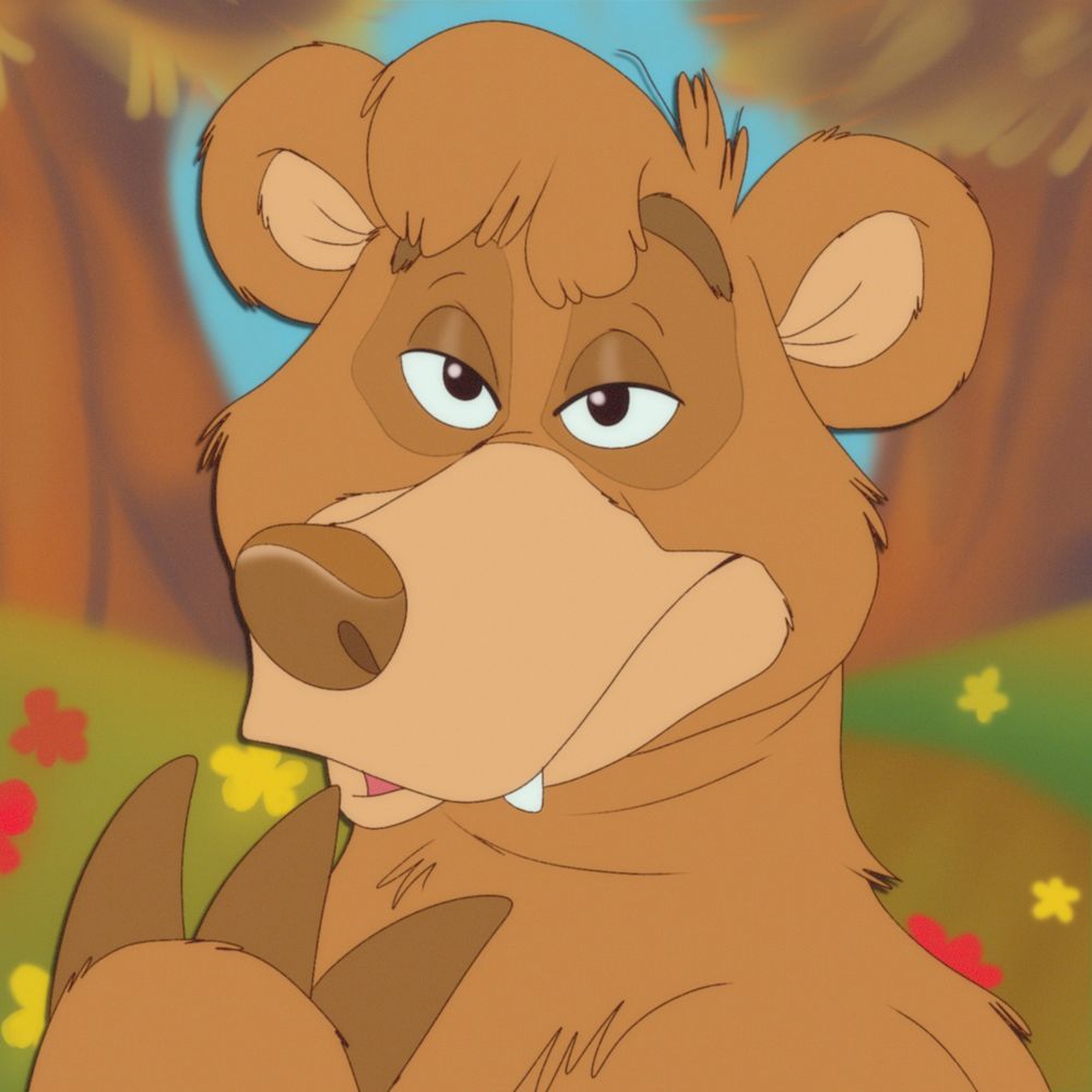 A bear placing it's paw below it's mouth. Forest background.