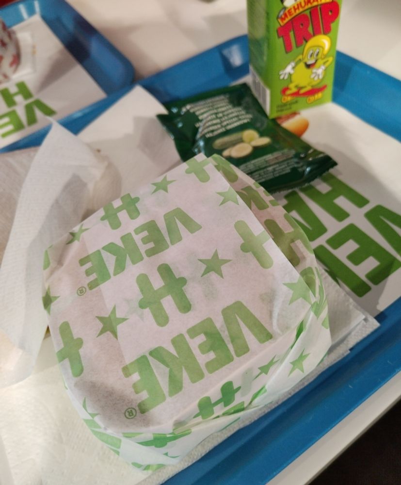 a Hesburger vegetarian burger meal with fries, a pear juice box and a cucumber mayo dip.
