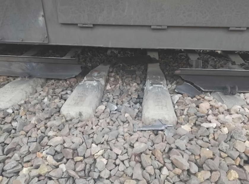 Photo shows a train halted over a missing track part, which is roughly 50 cm long. The train wasn't damaged while passing the damaged fragment and nobody on the train was harmed. 