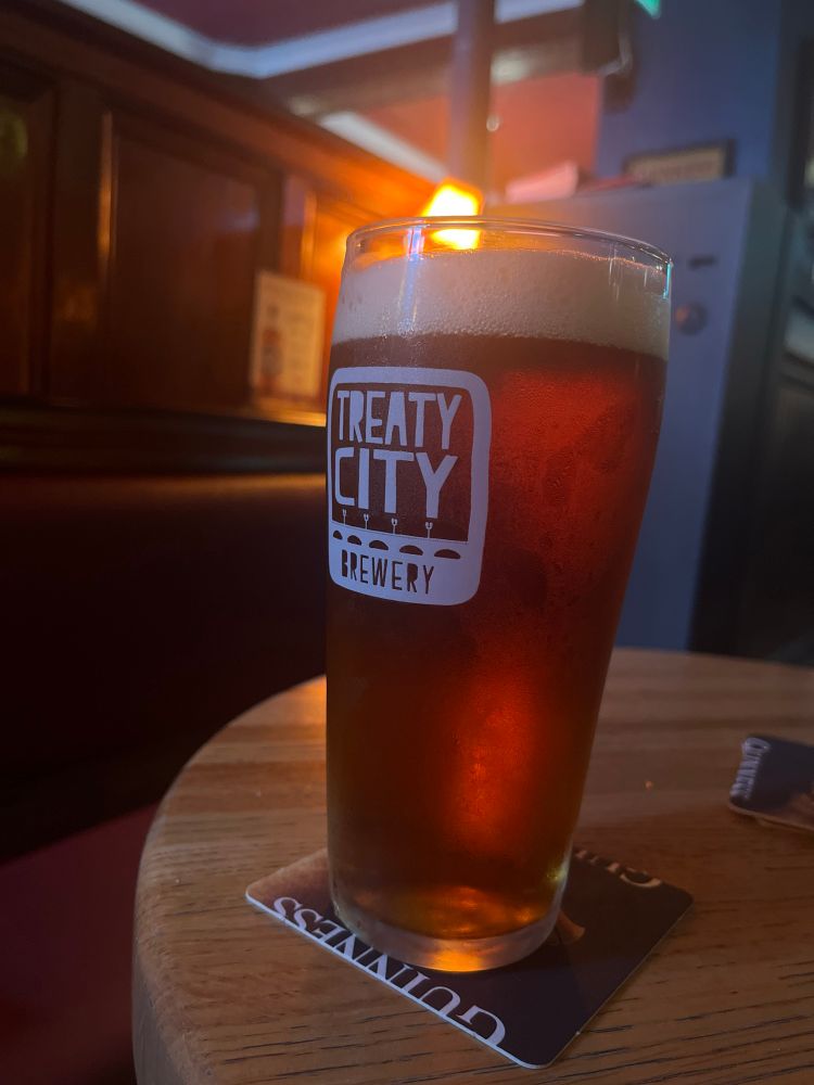 A pint of pale ale in the afternoon in a dimly lit pub in Limerick City