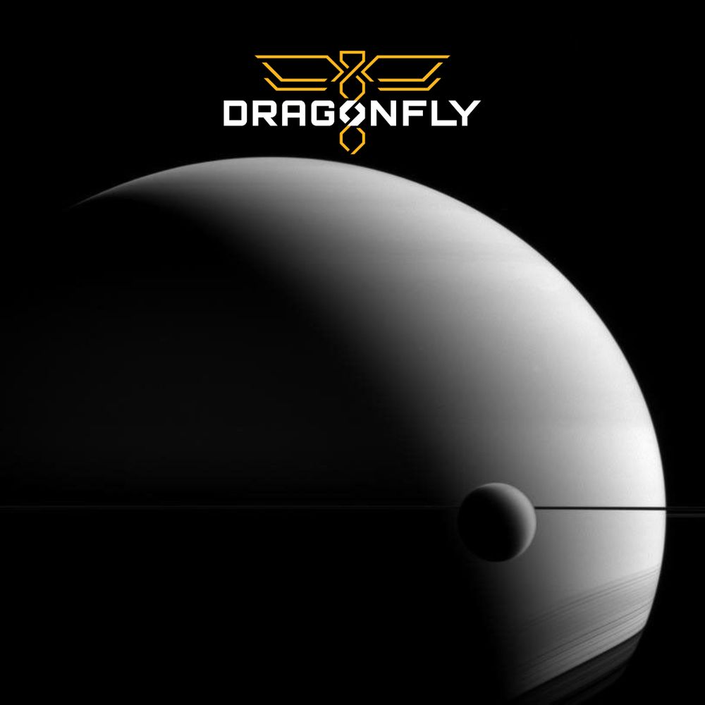 📸: A monochrome image featuring the logo of the Dragonfly Mission above a photo of Saturn with its moon Titan in the foreground. The overall scene is dark with a soft haze on the curve of the planets. (Photo Credit: NASA/JPL-Caltech/Space Science Institute)