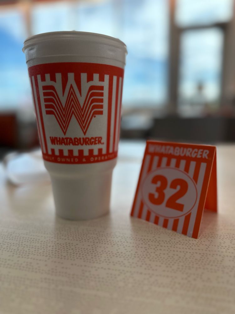 A table tent and styrofoam cup at Whataburger 
