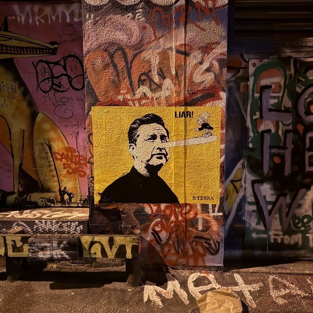 Pierre Poilievre, the Canadian politician, is depicted in street art resembling Pinocchio. Jiminy Cricket, the conscience of Pinocchio, is seen at the end of his long nose, exclaiming, Liar!