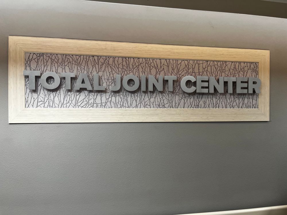 sign on wall that says “TOTAL JOINT CENTER”