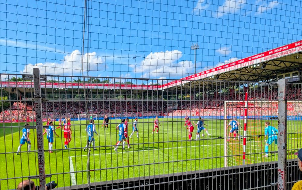 Footballers battle for the ball in the air