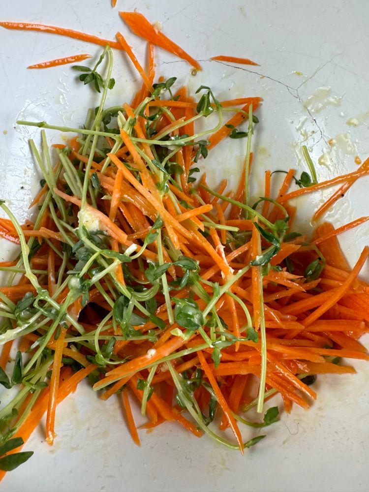 Carrot and pea shoots tossed with a ginger dressing.