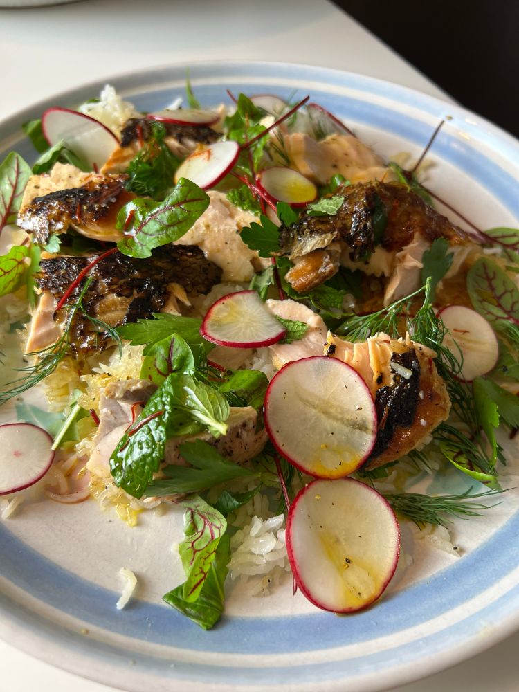 Greens, herbs, radishes, Arctic Char, and crispy rice.