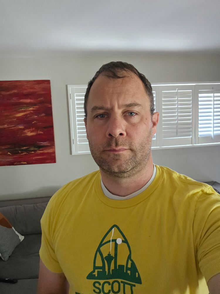 A middle aged man with one of his lucky Scott Fish Bowl shirts and one of his lucky WRs already drafted 