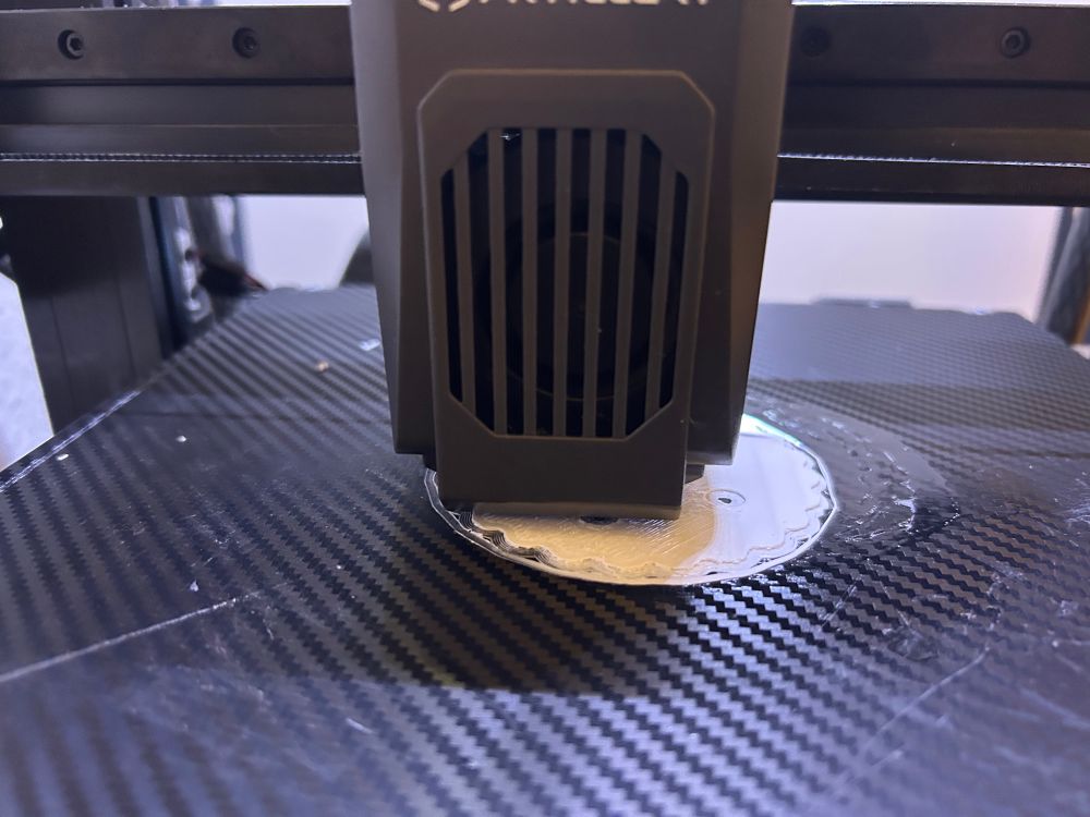 Close up photo of a 3D printer printing a part for a robot arm.