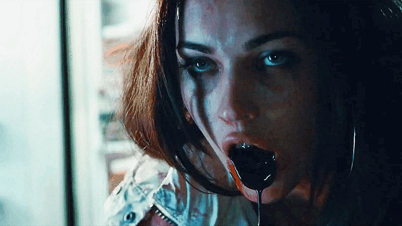 megan fox in jennifer’s body (2009) throwing up near black blood. her hair is down her stare is blank, her mouth is open 
