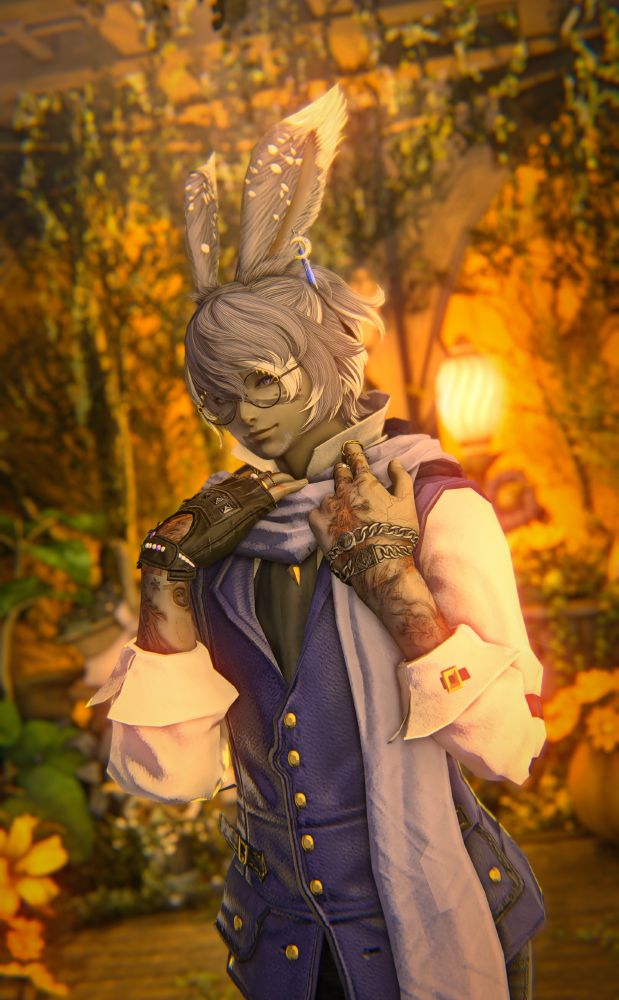 An edited gpose of Kel standing in a room of autumnal nature with an orange glow behind him. He's wearing a white shirt rolled up his forearms, a blue vest, black tie, a light blue scarf, one glove with a bracelet on the other hand, and celestial-themed glasses. His hands are holding the scarf over his shoulders while he coyly looks at the camera, his expression a subtle smile through half-lidded eyes.