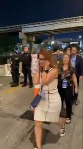 A woman at the Democratic National Convention covers her ears as the names of murdered Palestinians are spoken over a megaphone.