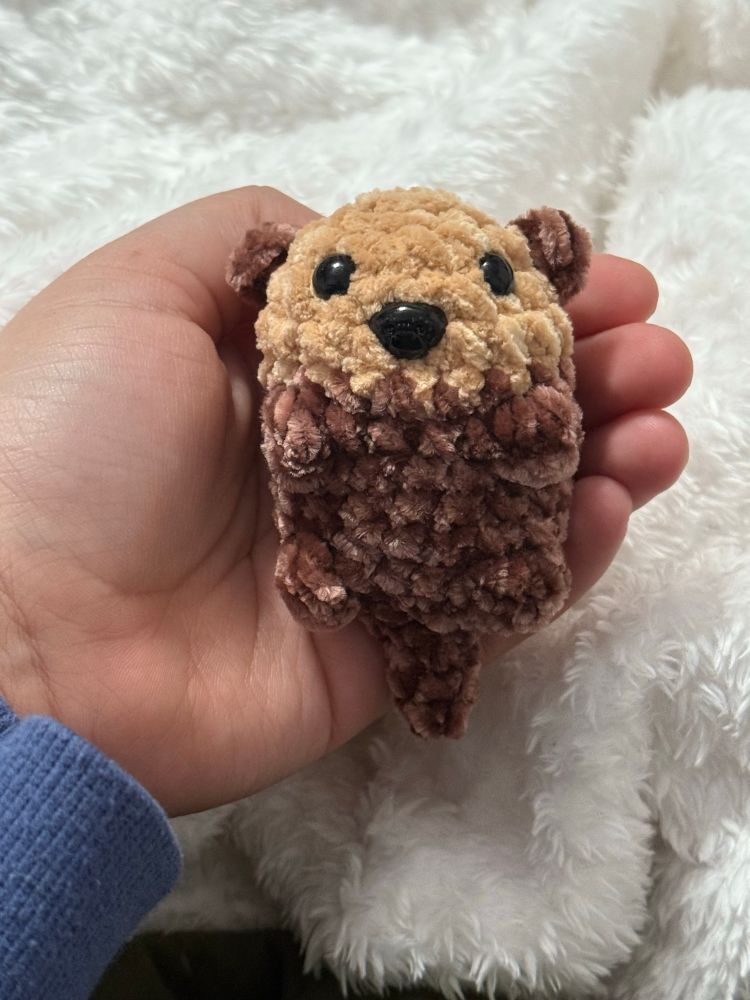 Photograph of a brown crochet otter
