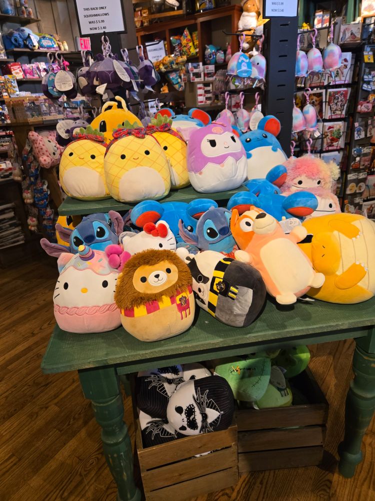 Variety of squishmallow plushies on a table