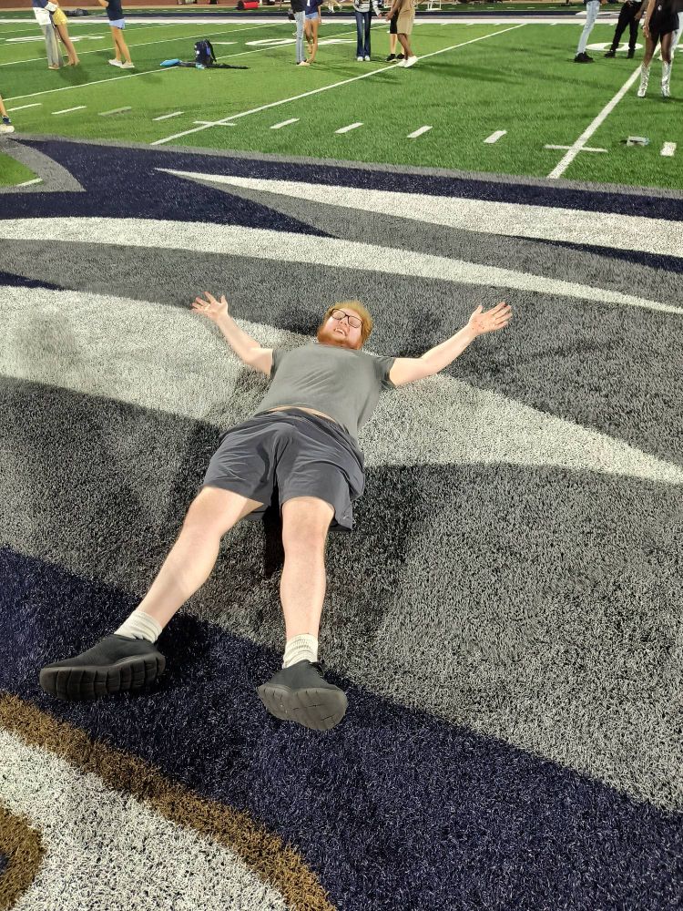 picture of me laying down at midfield at Georgia Southern