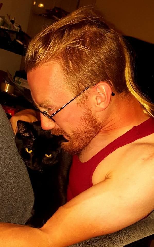 Me, years ago, playfully nibbling my cat Yuuyuu's ear. She's an anxious little sweetheart, so when she does ask for attention I'm sure to give it to her