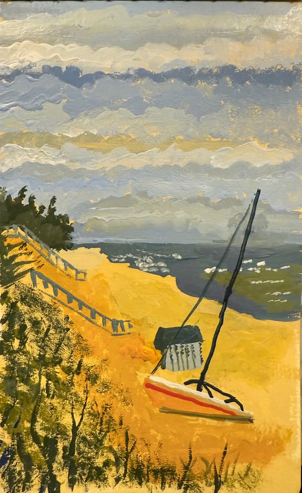 A sailboat pulled up on the shores of Lake Michigan on an early spring day as the land slowly warms under the afternoon sun.