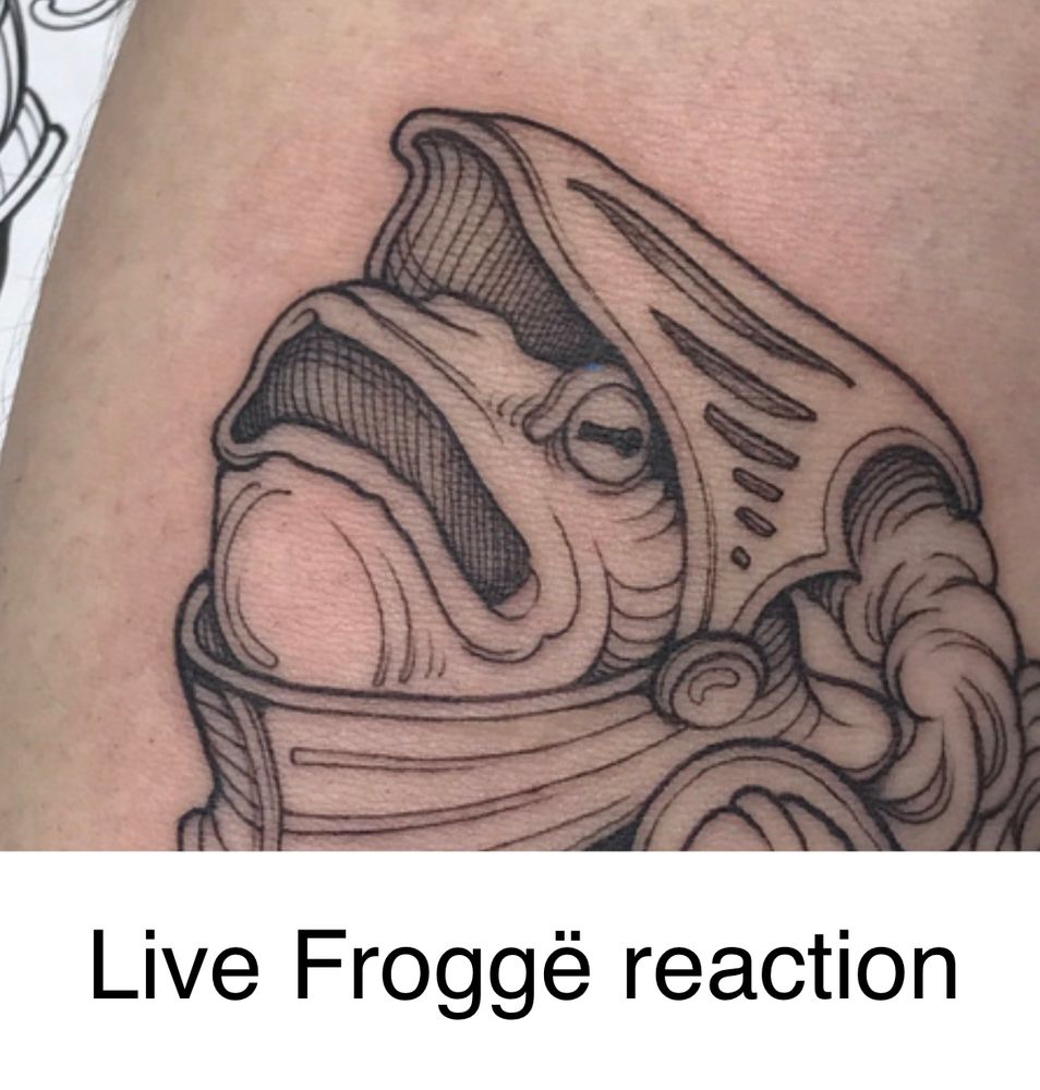 A zoomed in crop of the above image of a tattoo of a silly goofy frog man in armour looking dismayed. The text says: Live Froggë Reaction