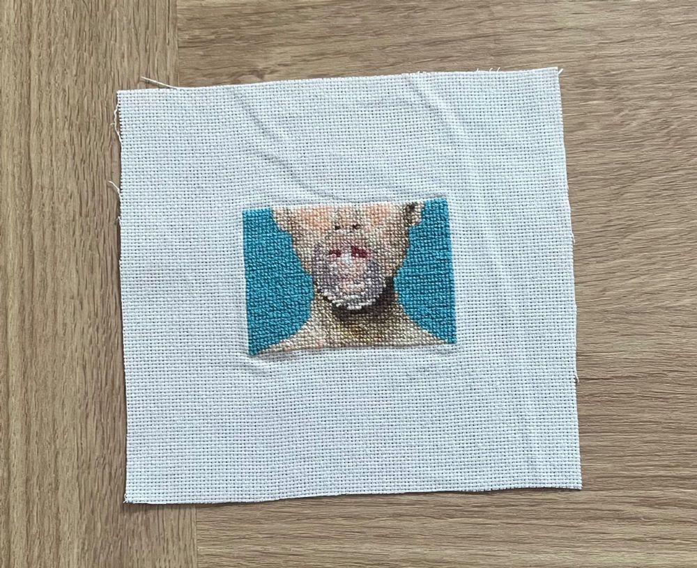 A cross stitched version of American Candy by The Maine, an album cover which features a woman blowing bubblegum.