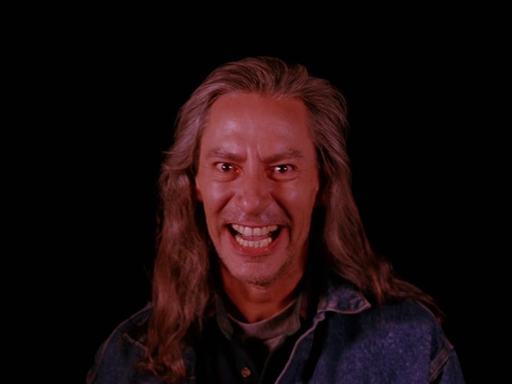 The Twin Peaks character BOB stares into the camera, smiling maniacally