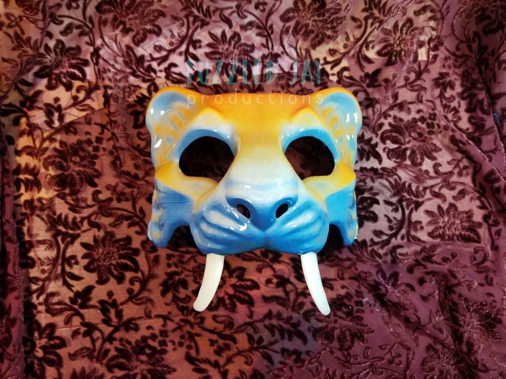aroace colored sabertooth tiger masquerade mask on a plum filigree background