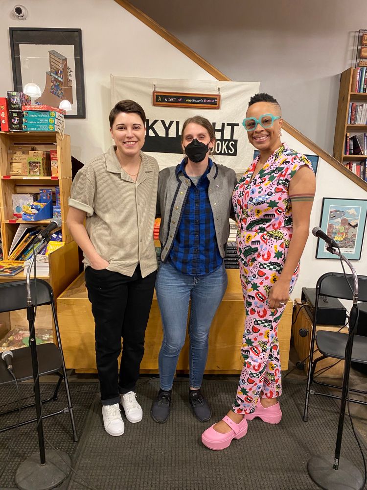 Three nonfiction authors posing in front of Skylight Books sign