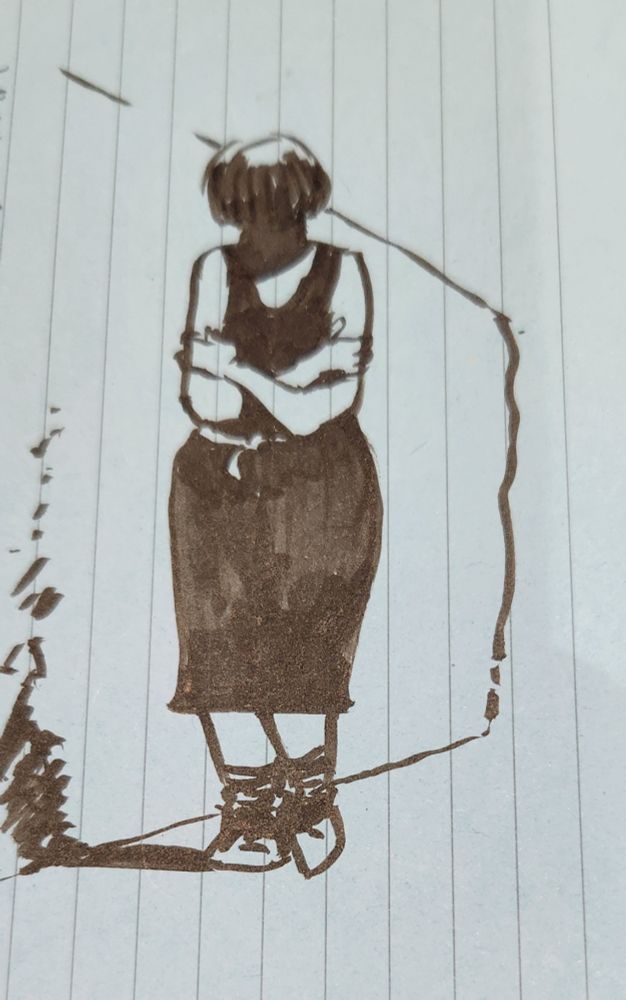 A woman walking along near a wall.

Hugging herself

Face in shadow