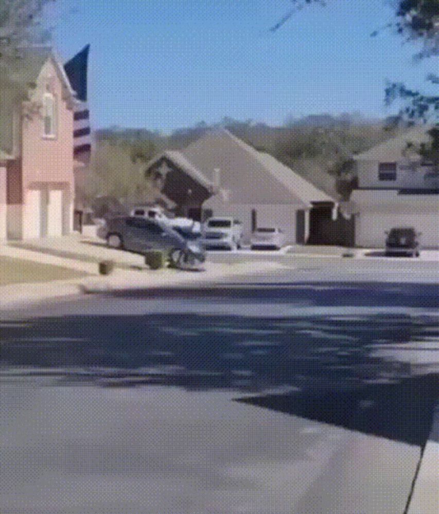 cars are parked on the side of the road in front of houses