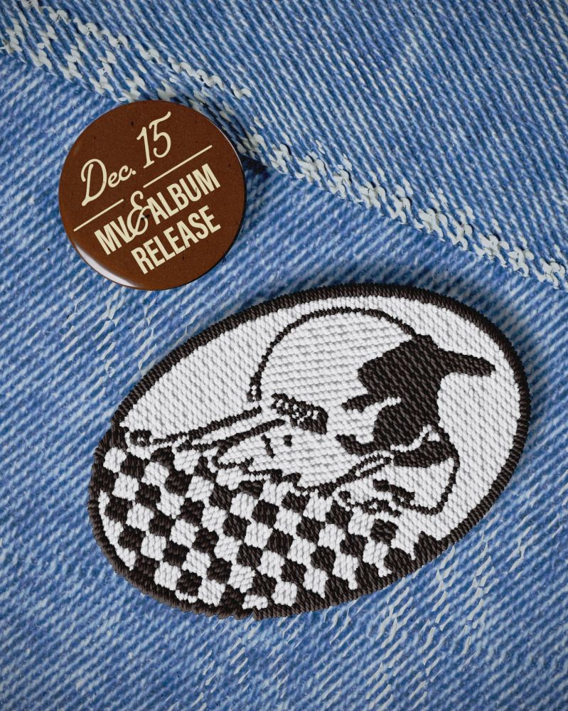 A patch displaying a racing helmet, linked to SHINee Minho's single schedule.