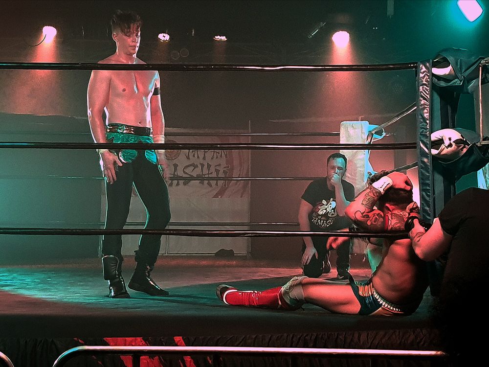 A shot from after the match. Robbie Eagles sitting in the corner holding his head while Kyle Fletcher stands tall