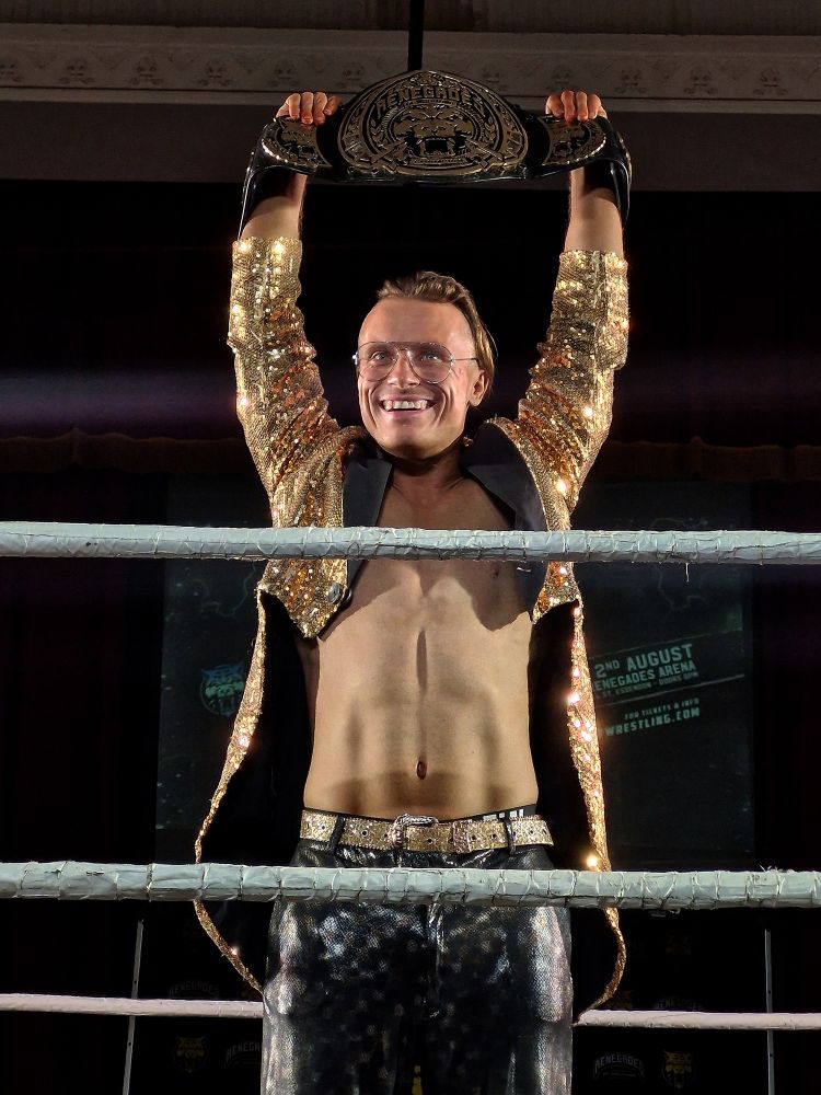 Lochy Hendricks holding the Renegades title over his head for the first time