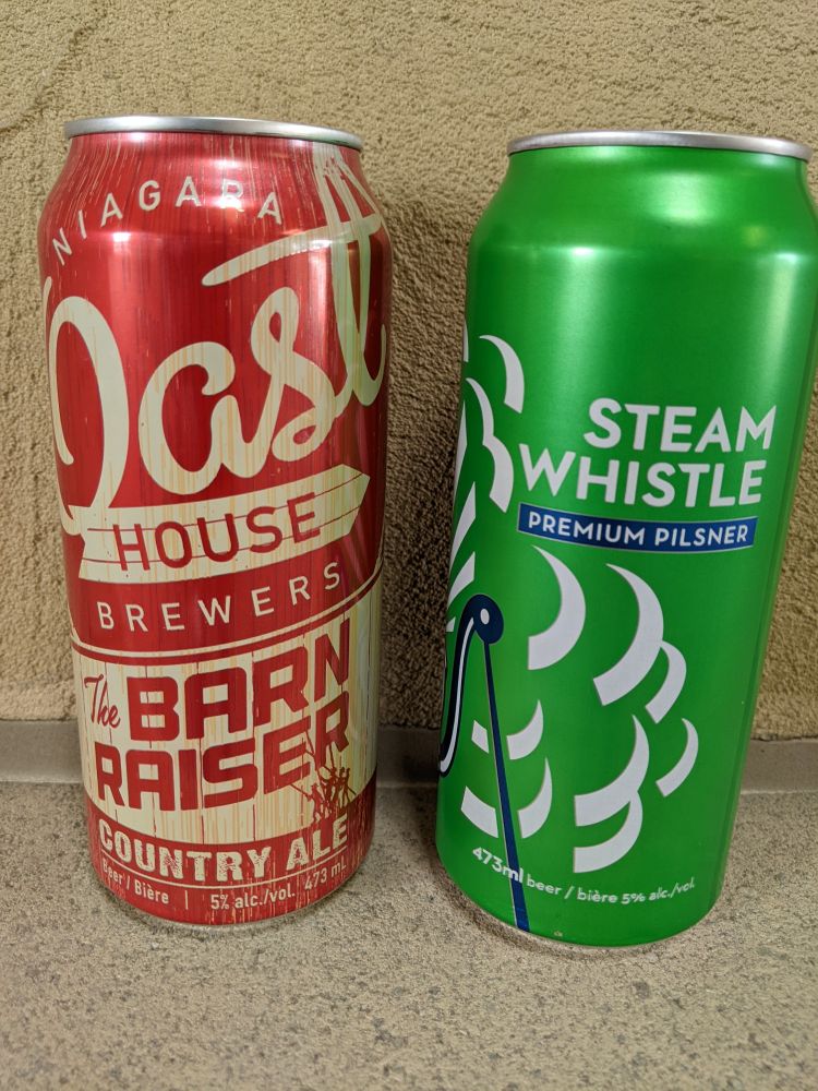 Cans of Oast House Barn Raiser and Steam Whistle Pilsner