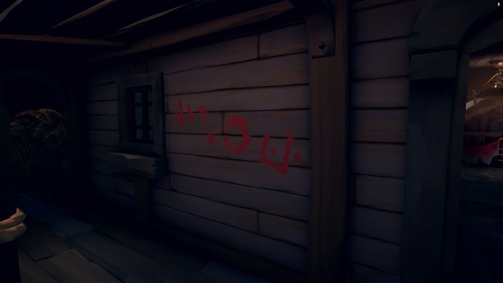 Red painted Skeleton Runes drawn on the side of the wall of the tavern at Dagger Tooth Outpost.

It can be translated from left to right to the Reaper's Bone famous motto:

PIRATES FOR ALL ETERNITY.