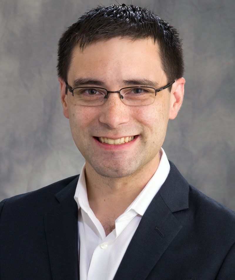 Professional headshot of Charles Sing. 