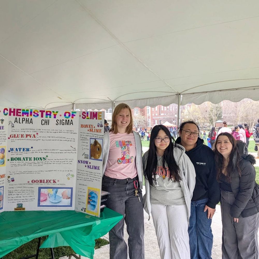 Alpha Chi Sigma members pose with their poster, "The Chemistry of Slime". 