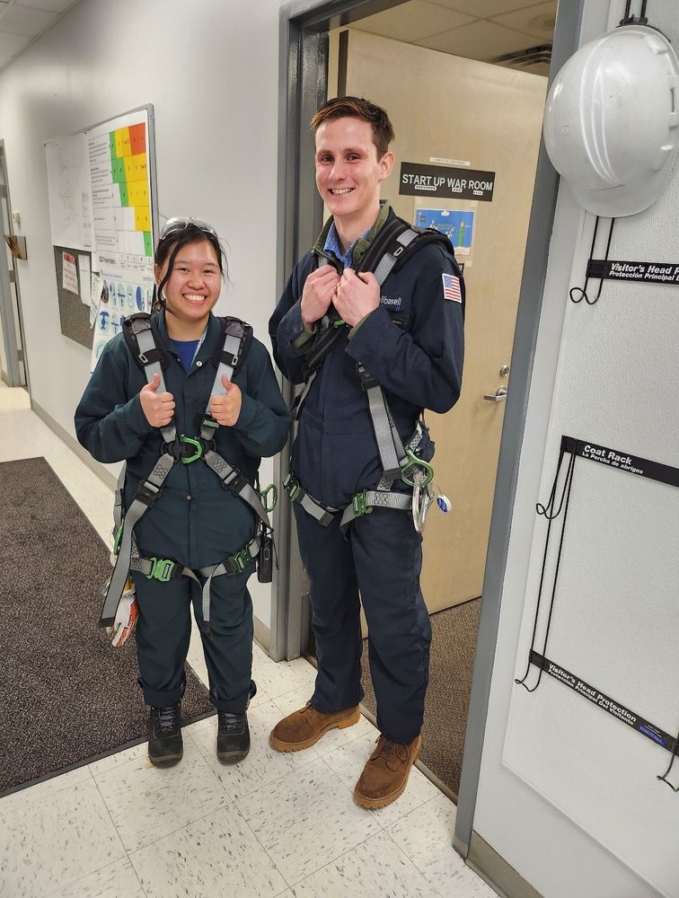 Zylle Constantino and a co-worker in their work wear jumpsuits and harnesses to check out different equipment. 