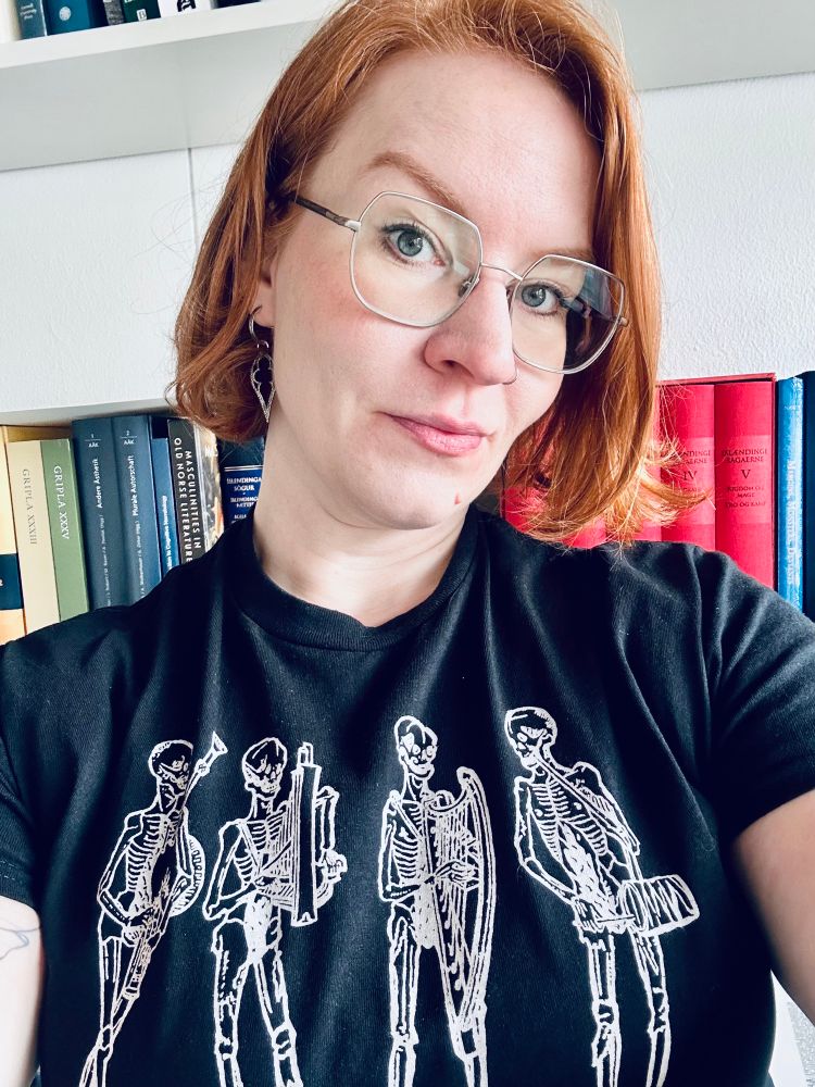 Picture of me wearing a black shirt with white skeletons playing musical instruments on it