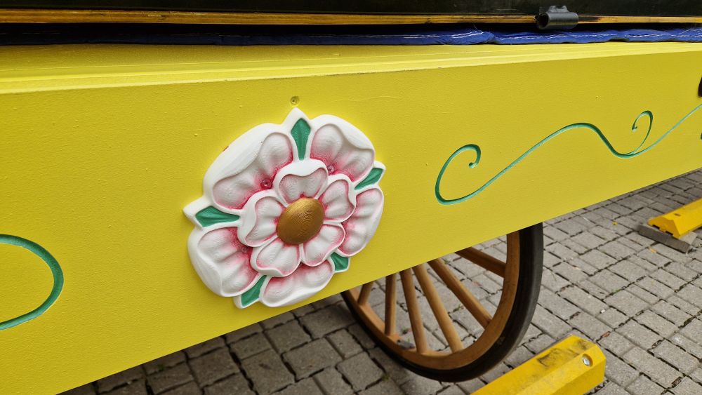 White York rose on yellow pageant wagon