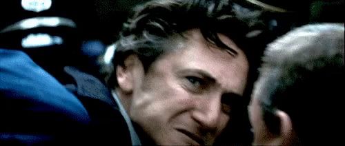a close up of a man 's face with a sign in the background that says ' a '
