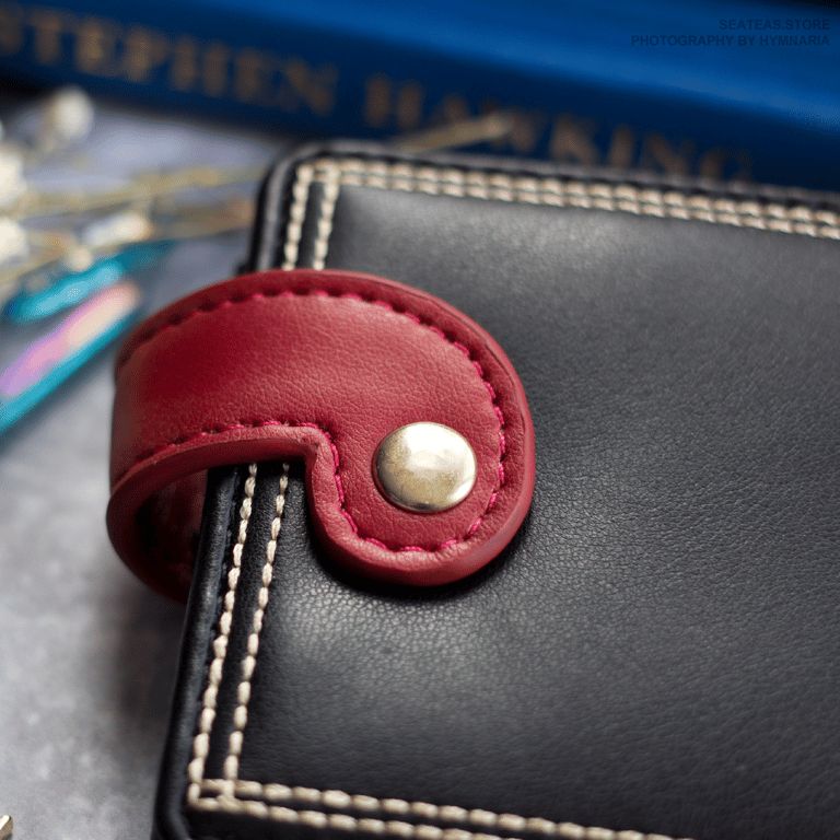 back of the bifold wallet. Graha's tail makes the snap closure mimicking the back of his character.