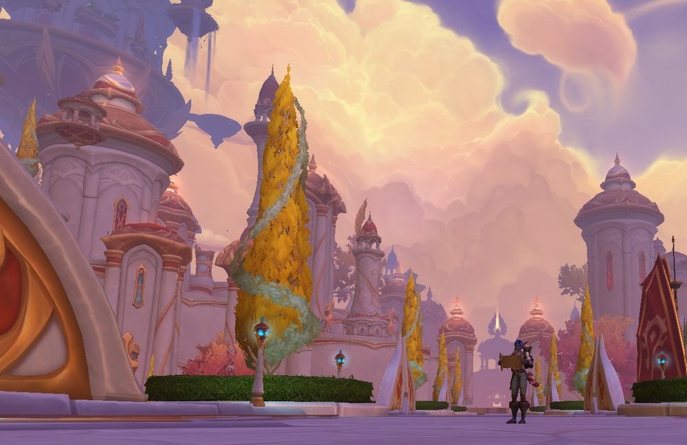 Screenshot of a night elf player standing on a bridge called, "The Shining Span" with the entrance of Silvermoon visible in the distance behind her. She is looking at a map. Large, white clouds hang above in a blue sky, a light as bright as the sun in late afternoon shines from above and behind. Narrow buildings of white, decorated with red and gold that have spires reaching toward the sky, stand on the side of the bridge. A topiary of a gold tree stands to the left. Street lamps glow faint blue along the sides of the bridge.