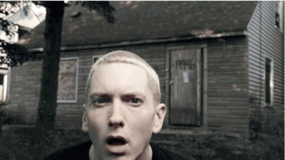 a man with a surprised look on his face stands in front of a house that says 1990 on the door