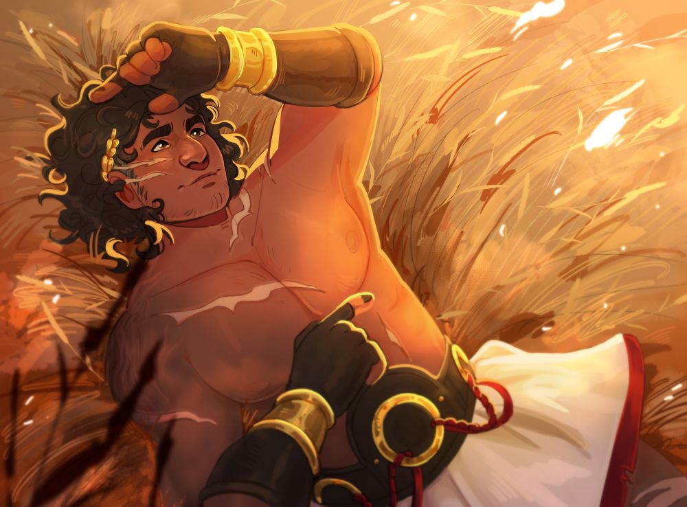 Alekos laying in a golden field of grass, relaxing and smiling! 
