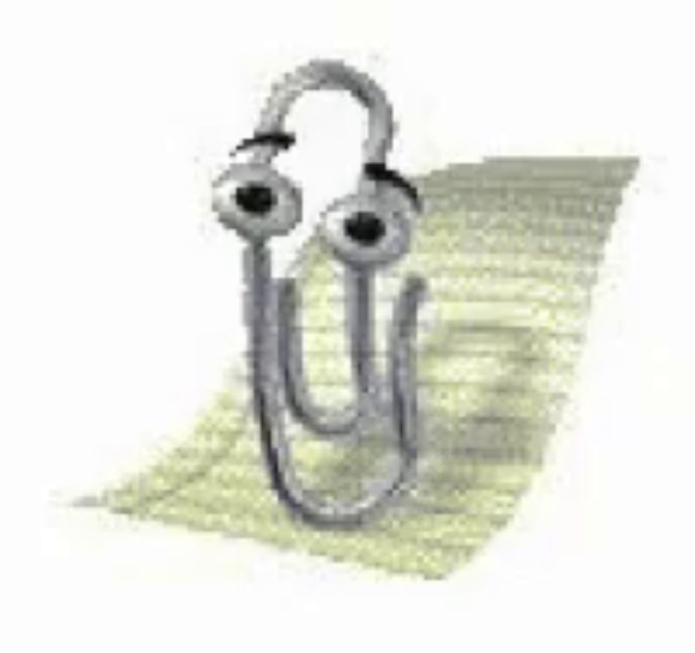 a paper clip with a face on it is sitting on top of a piece of paper .